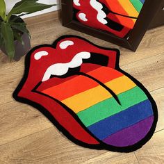 the rug is shaped like a rainbow tongue