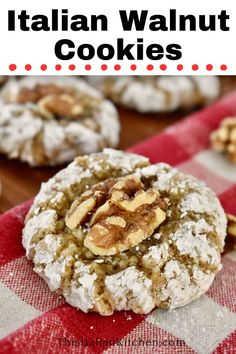 cookies with walnuts and powdered sugar are stacked on top of each other in front of a checkered tablecloth