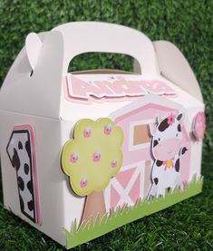 a cow themed box sitting in the grass