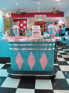 an ice cream shop with checkered floor and black and white tiles on the floor