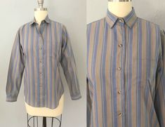 "Vintage Lee shirt from the 70's era! Blue, tan, yellow, and red vertical stripes. Buttondown front, long slim sleeves, two buttons cuffs, and a left breast pocket. Thin cotton blend. Shirttail hem. Fits a size medium but please double-check measurements below to ensure the best fit for you. MEASUREMENTS: Taken with garment laying flat, in inches, doubled: Bust: 38\" Waist: 35\" Shoulder: 13\" Sleeve width: 14\" Length: 25\" Label/ Era: Lee | 1970 Stated Size: 7/8 Fabric: Polyester cotton blend 70s Era, Vertical Stripes, Striped Blouse, Vintage Shirts, Vintage 70s, Womens Clothing Tops, 1970s, Blouses For Women, Button Down Shirt