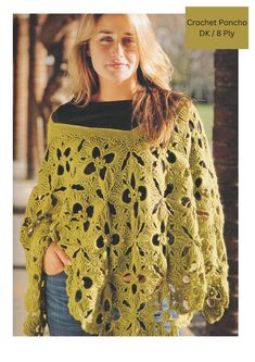 a woman wearing a green crochet poncho with holes in the middle