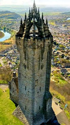 an aerial view of a castle in the middle of a city with lots of green grass