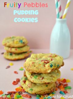 three cookies stacked on top of each other with colorful sprinkles around them