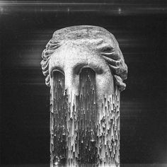 a statue with water flowing out of it's face