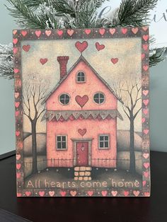 a card with a pink house and hearts on it