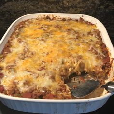 a casserole dish with meat and cheese in it on top of the stove