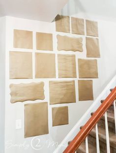 some brown squares are on the wall next to a banister and stair railings