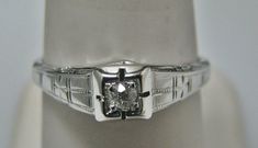 "For Sale: (1) H111 Beautiful Cube Shaped Diamond Ring in 18k White Gold from 1930's PLEASE READ ENTIRE DESCRIPTION BEFORE PURCHASING Please see pictures for more details! This gorgeous ring features approx. .06 ct diamond in the center of the ring. The ring has diamond as in the cube in the middle and beautiful design from the sides. This is gorgeous filigree mounting down the side. The ring is stamped 18k. This ring is from the 1930's. A beautiful piece for a any special occasion! What a great Vintage Diamond Ring, Gorgeous Ring, Vintage Diamond Rings, Filigree Design, White Band, Filigree Ring, Silver Chain Necklace, Saint Louis, Wristwatch Men