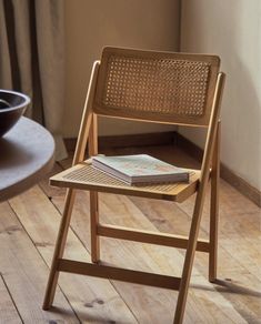 a wooden chair with a book on top of it