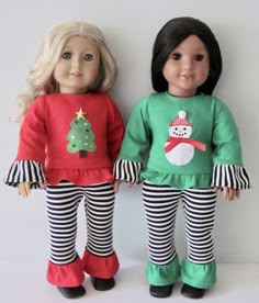 two dolls are standing next to each other