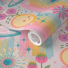 a colorful wallpaper with flowers and animals on it's surface, next to a roll of toilet paper