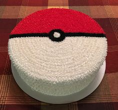 a pokemon cake with red and white frosting