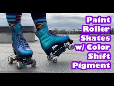 two roller skates with blue and purple paint on them are shown in this image