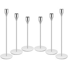 four metal poles and three white plates on a white background