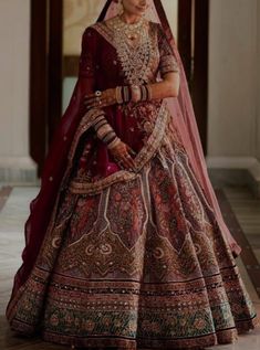 a woman in a red and gold bridal gown