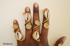 African cowrie shell rings tribal rings African jewelry adjustable handmade rings unisex African fashion tribal accessories holiday gifts PRODUCT SPECIFICATIONS: Size - adjustable Materials - cowrie shells and brass wire ADDITIONAL INFORMATION New and unworn: Yes Handmade in Kenya: Yes Other jewelry in my shop: https://www.etsy.com/shop/shakava Adjustable Spiral Jewelry For Beach, Unique Handmade Cowrie Shell Jewelry, Unique Cowrie Shell Jewelry, Afro Jewelry, Cuffs Diy, Shell Rings, Dope Jewelry Accessories, Wire Jewelry Rings, Full Finger Rings