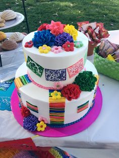 a multi layer cake sitting on top of a table