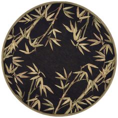 a round area rug with bamboo leaves on the top in black and beige colors,