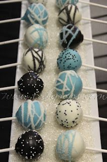 blue and white cake pops are on a rack