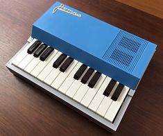 a blue and white piano sitting on top of a wooden table