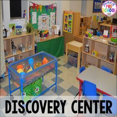 a classroom filled with lots of toys and desks next to a green sign that says discovery center