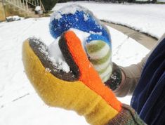 someone is holding their mitts in the snow