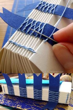 someone is making an origami boat out of book pages with blue tape and scissors