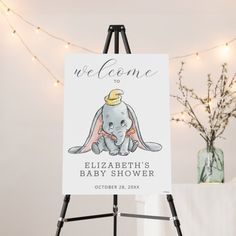 a welcome sign for a baby shower with an elephant wearing a crown on it's head