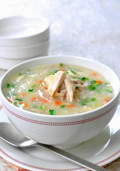 a white bowl filled with soup on top of a plate