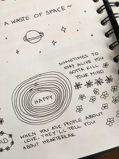 an open notebook with handwritten notes and doodles on the pages that say happy