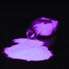 a purple light is shining on the ground