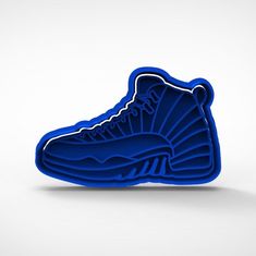 a blue air jordan shoe shaped object sitting on top of a white surface