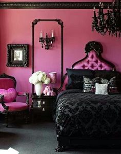 a bedroom with pink walls, black furniture and chandelier on the wall in it