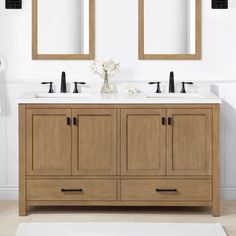 a bathroom with two sinks and mirrors on the wall