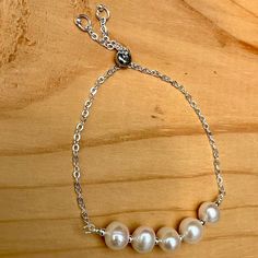 This adjustable Pearl bracelet is made with tarnish resistant silver plated wire and chain. The clasp slides to adjust up to 9 inches. The pearls are freshwater pearls and are a June birthstone. Fast free domestic shipping from Portland, Oregon. I try to ship the same or next day of your order. Your item will arrive in a gift box with bow and my shop name suitable for gift giving. I am happy to send it directly to your gift recipient and include a card with your special message. Just mention it in your buyers notes when you order. You can follow me on Instagram @banbajewelry Pinterest @banba3 Adjustable Sterling Silver Pearl Drop Bracelet, Adjustable Sterling Silver Pearl Charm Bracelet, Adjustable Pearl Bracelet For Anniversary, Adjustable Pearl Chain Bracelet For Anniversary, White Adjustable Pearl Bracelet, Adjustable Silver Bracelet With Pearl Charm, Adjustable Silver Pearl Bracelet Gift, Adjustable Silver Pearl Bracelets, Adjustable Silver Pearl Drop Bracelet