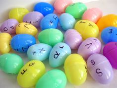 an assortment of colored eggs with numbers written on the top and one in the middle