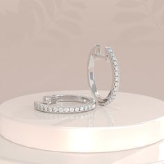 ✥ Discover elegance and sophistication with our Round Pave CZ Hoop Diamond Earrings for Women, crafted in solid gold. These exquisite earrings feature a dazzling array of pave-set cubic zirconia stones, meticulously placed to radiate brilliance from every angle. Perfect for any occasion, whether it's a glamorous evening out or adding a touch of sparkle to your everyday ensemble. The solid gold setting ensures durability and timeless appeal, making them a cherished addition to your jewelry collection. Elevate your style effortlessly with these hoop earrings that combine classic design with modern glamour, promising to enhance your natural beauty with their shimmering allure.✦ Main Stone Details✧ Type: Stud Earrings✧ Shape: Round Cut✧ Stone Size: 5.5ctw ✧ Width: 6.0 mm✧ Moissanite Details: D Diamond White Round Cut Diamond Hoop Earrings, Luxury Huggie Earrings With Pave Setting In Cubic Zirconia, Diamond White Brilliant Cut Cubic Zirconia Huggie Earrings, Diamond White Cubic Zirconia Huggie Earrings With Prong Setting, Timeless Diamond Earrings With Pave Setting For Anniversary, Dazzling Diamond White Hoop Earrings With Brilliant Cut, Elegant Brilliant Cut Cubic Zirconia Huggie Earrings, Anniversary Huggie Earrings With Brilliant Cut Cubic Zirconia, Diamond Hoop Earrings With Halo Design