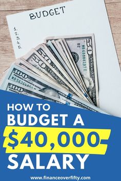 a pile of money sitting on top of a table next to a blue and yellow sign