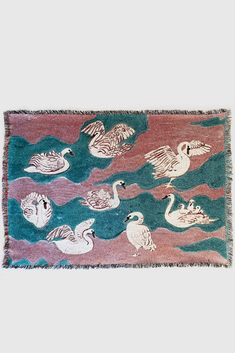 a rug with ducks and swans on it