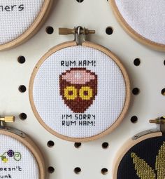 some cross stitchs are hanging on the wall