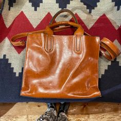 Cute Leather Bag. The Color Is Brown. Handles And Shoulder Strap Are Very Sturdy. You Could Fit A Tablet Or Small Laptop In Bag. There Are Three Sections In This Bag. The Center Section Zips And It Has Two Small Pockets And A Pocket That Zips. I Bought This And I Never Used It. Ships From A Smoke Free Home. Trendy Rectangular Cognac Bag, Trendy Cognac Rectangular Bag, Tan Satchel With Detachable Strap For Everyday Use, Everyday Tan Satchel With Detachable Strap, Tan Bag With Detachable Strap For Everyday Use, Tan Satchel With Adjustable Strap For Daily Use, Everyday Tan Bag With Detachable Strap, Tan Shoulder Bag With Detachable Handle For On-the-go, Trendy Cognac Shopping Bag