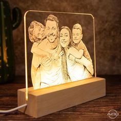 a wooden block with an image of three people on it and a string attached to the base