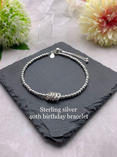 "*ITEM DESCRIPTION* This lovely beaded bracelet is made using 3mm sterling silver beads, with 4 fine silver circle charms with each circle representing each decade. Each bracelet has a sterling silver 925 tag attached.  This bracelet is also available with 3, 5 or 6 circle charms. Please see separate listings below.  30th birthday bracelet  https://etsy.me/2pyRTOe  50th birthday bracelet  https://etsy.me/2HmKY4Q 60th birthday bracelet  https://etsy.me/2t7MoYr  There is a choice of silver or gold Adjustable Sterling Silver Bracelet For Birthday, Silver Dainty Beaded Bracelets For Anniversary, Dainty Silver Beaded Bracelets For Anniversary, Dainty Sterling Silver Beaded Bracelets For Anniversary, Silver Hypoallergenic Beaded Bracelets For Birthday, Anniversary Silver Beaded Bracelets, Silver Beaded Birthstone Bracelets For Birthday, Silver Beaded Bracelet With Birthstone For Birthday, Silver Beaded Birthstone Bracelets For Birthdays