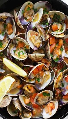 clams with tomato sauce and pasta in a skillet