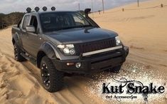 the truck is driving through the sand dunes