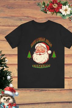 Celebrate the holiday season with a touch of nostalgia! This retro-inspired 'Have a Holly Jolly Christmas' black t-shirt features a cheerful Santa design, perfect for cozy gatherings or gifting. Pair it with your favorite winter accessories to spread festive vibes all season long. Tap now to shop and bring holiday cheer to your wardrobe! 🎅✨ #ChristmasFashion #RetroHolidayStyle #SantaTee #t-shirt Santa Tee, Holly Jolly Christmas, Retro Santa, Santa Shirt, Santa Shirts, Merry Christmas Santa, Jolly Christmas