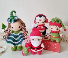 crocheted christmas ornaments are displayed on a white surface with other decorations and items