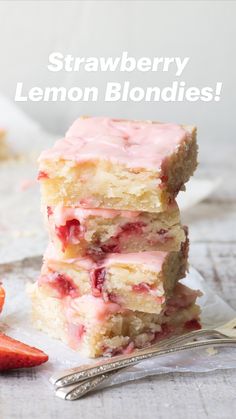 strawberry lemon blondies stacked on top of each other next to strawberries and a fork