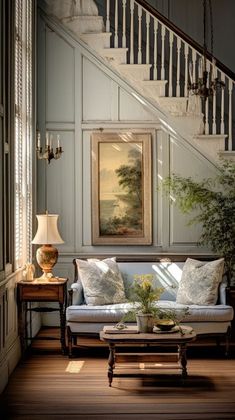 a living room filled with furniture and a painting on the wall next to a stair case